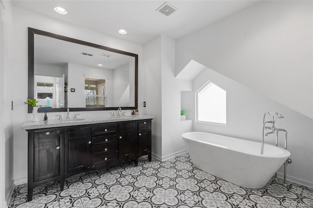 449 S Humboldt St, Denver, CO 80209 - full bathroom with baseboards, a freestanding bath, double vanity, and recessed lighting