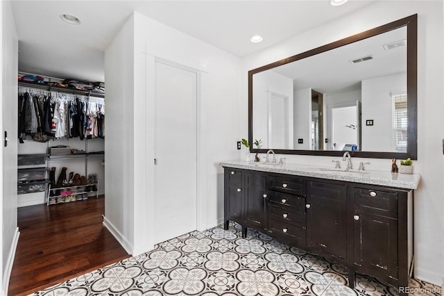 449 S Humboldt St, Denver, CO 80209 - full bath with double vanity, a spacious closet, baseboards, and recessed lighting
