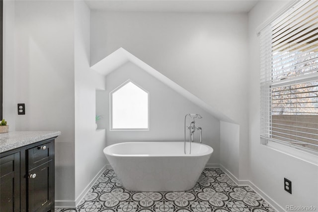 449 S Humboldt St, Denver, CO 80209 - full bathroom featuring a freestanding bath, baseboards, vanity, and tile patterned floors