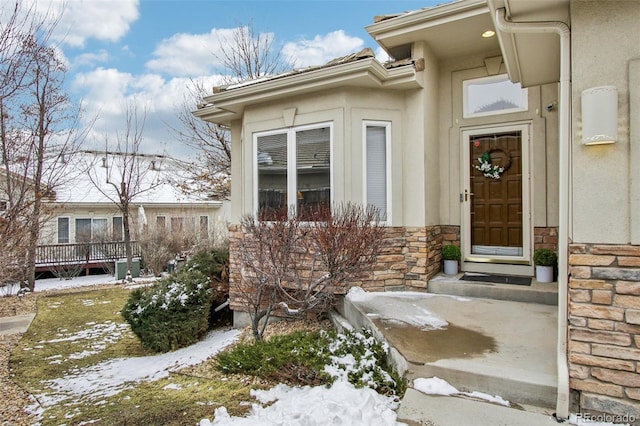 view of snow covered property entrance