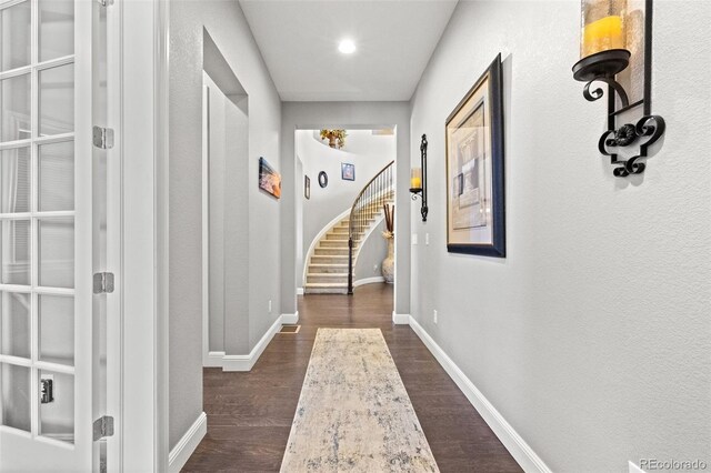 corridor with dark hardwood / wood-style flooring