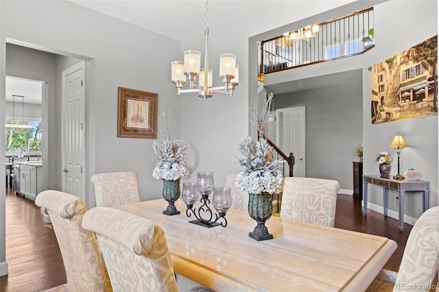 dining space featuring an inviting chandelier and dark hardwood / wood-style floors