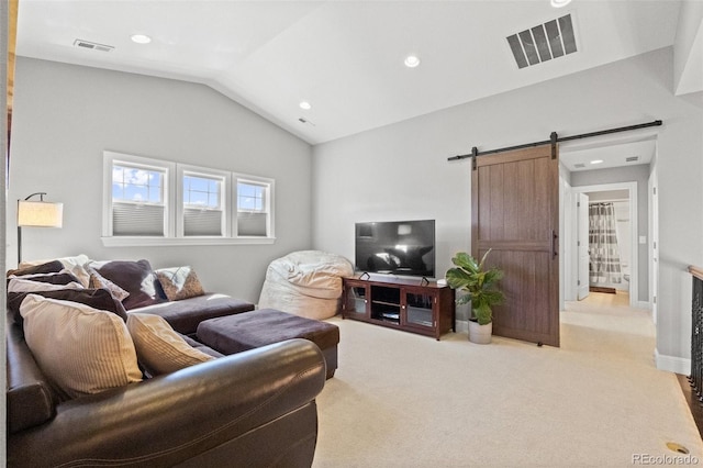 carpeted living room with vaulted ceiling and a barn door