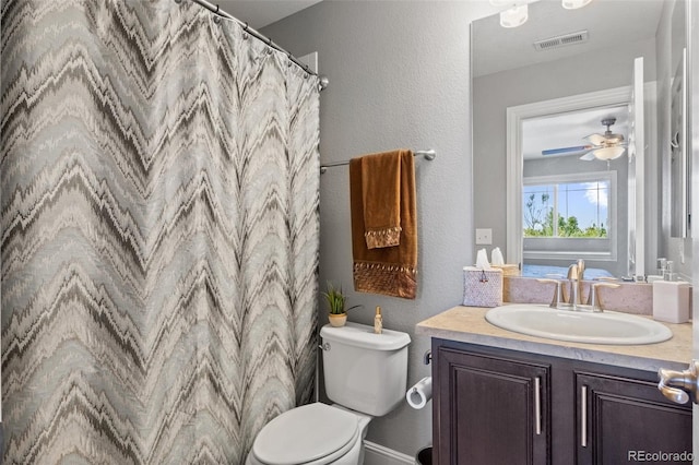 bathroom with vanity, toilet, and ceiling fan