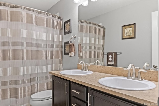 bathroom with vanity, toilet, and walk in shower