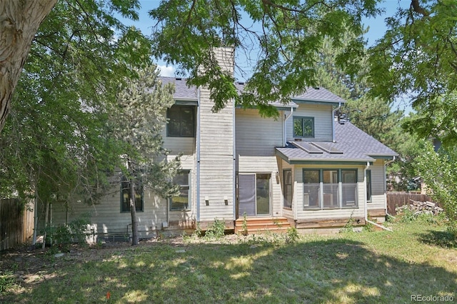 11210 Quivas Loop, Denver, CO 80234 - back of house featuring entry steps, a chimney, and roof with shingles