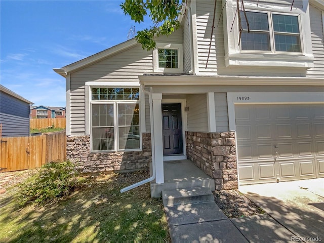19093 E Linvale Pl, Aurora, CO 80013 - view of front facade with stone siding and a garage