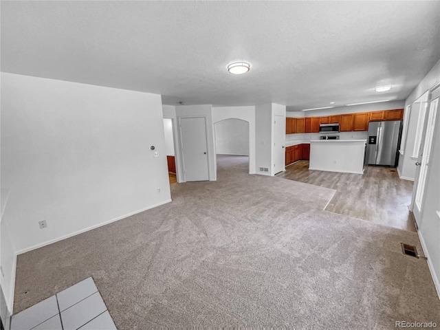 19093 E Linvale Pl, Aurora, CO 80013 - unfurnished living room with light carpet and arched walkways