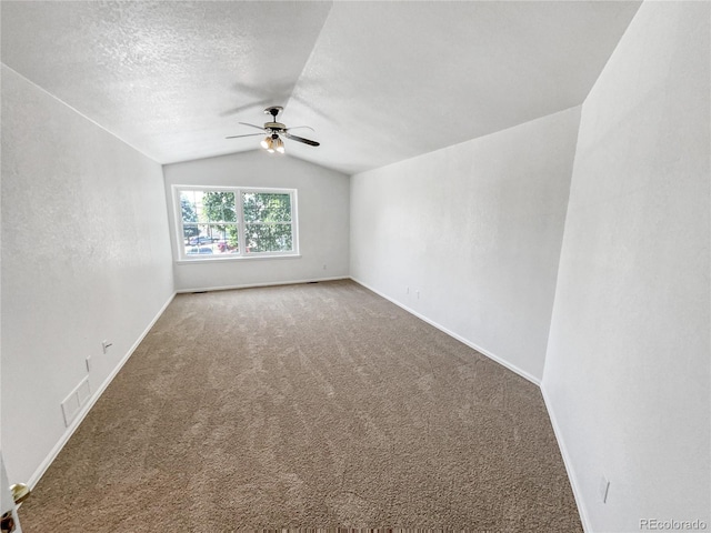 19093 E Linvale Pl, Aurora, CO 80013 - spare room with ceiling fan, vaulted ceiling, carpet, and a textured ceiling
