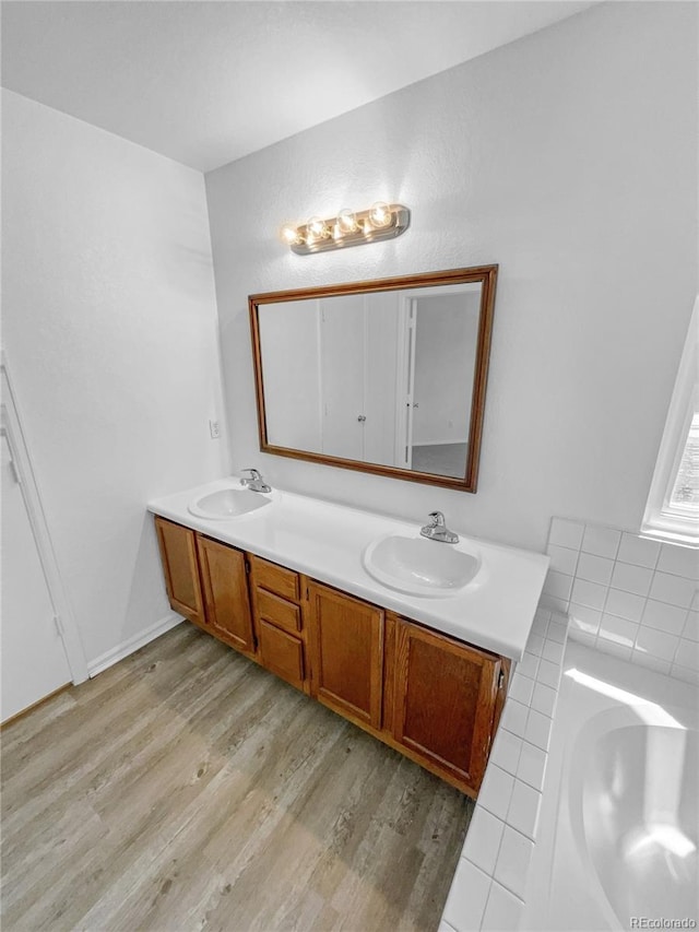19093 E Linvale Pl, Aurora, CO 80013 - bathroom with double vanity, wood finished floors, and a tub