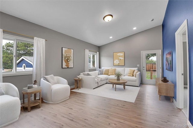 living room with recessed lighting, baseboards, lofted ceiling, and wood finished floors