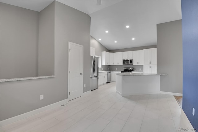 kitchen featuring baseboards, a peninsula, recessed lighting, white cabinets, and appliances with stainless steel finishes