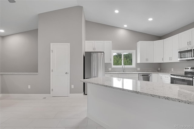 kitchen featuring light stone countertops, recessed lighting, a sink, stainless steel appliances, and white cabinetry