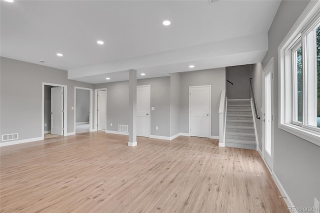 spare room with stairs, recessed lighting, visible vents, and light wood finished floors