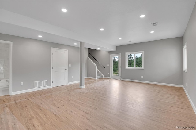 unfurnished room featuring visible vents, recessed lighting, stairway, light wood-style floors, and baseboards