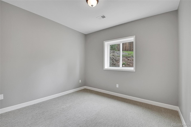 unfurnished room featuring carpet flooring, baseboards, and visible vents