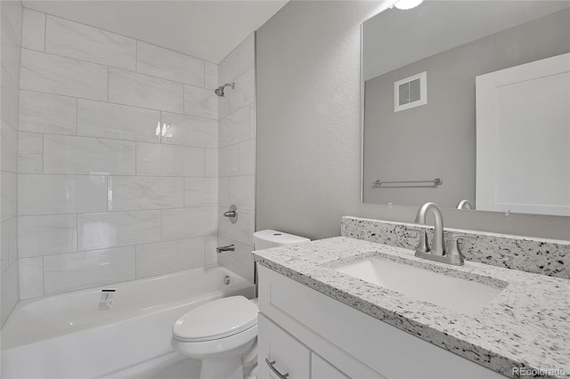 full bathroom featuring visible vents, vanity, toilet, and washtub / shower combination