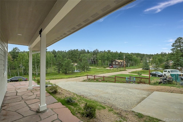 view of patio featuring covered porch and a view of trees