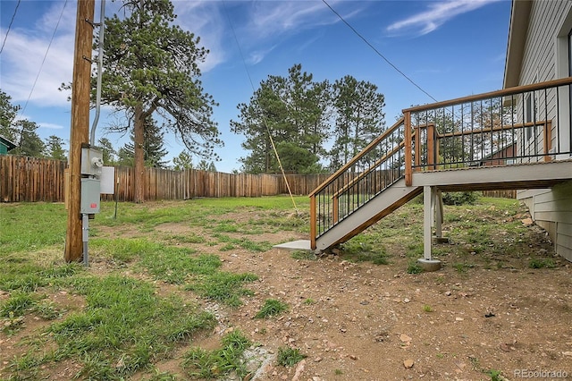 view of yard with stairs and fence