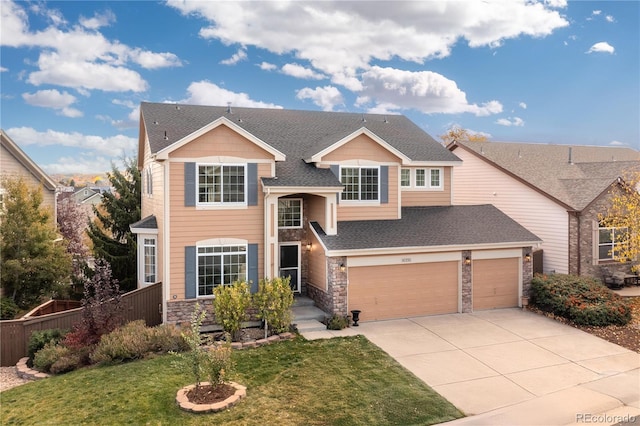 view of front of property with a garage and a front yard