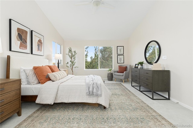 carpeted bedroom with ceiling fan and vaulted ceiling