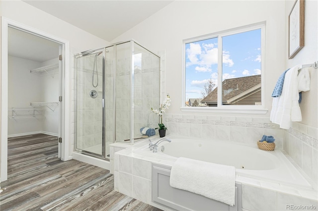 bathroom with hardwood / wood-style floors and separate shower and tub