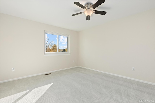 unfurnished room featuring ceiling fan and light colored carpet