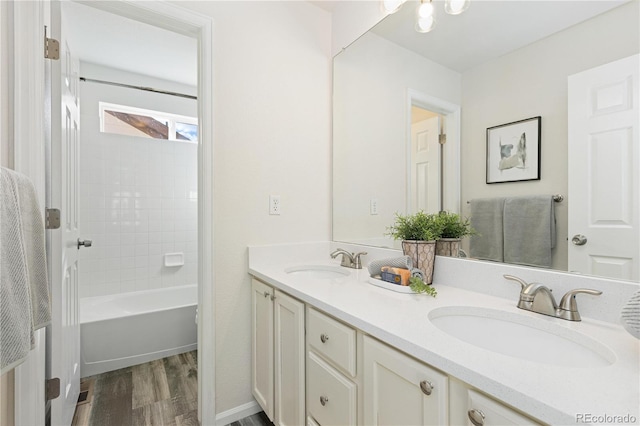 bathroom featuring hardwood / wood-style floors, vanity, and shower / tub combination