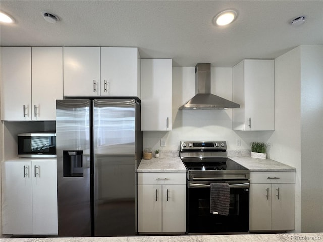 5060 N Walden Way, Denver, CO 80249 - kitchen with appliances with stainless steel finishes, wall chimney range hood, light countertops, white cabinetry, and a textured ceiling
