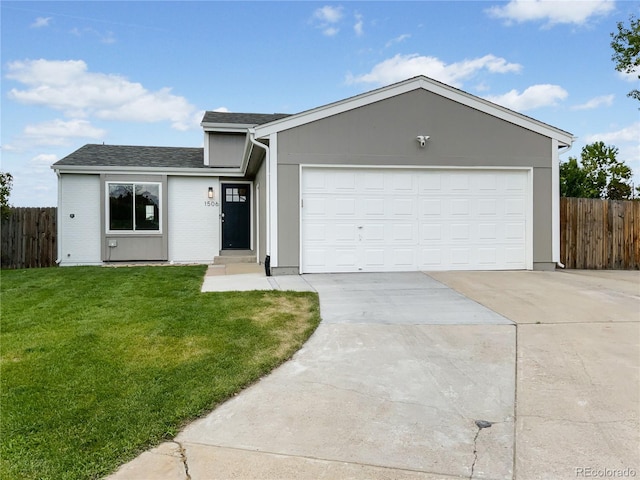 ranch-style house featuring a garage and a front lawn