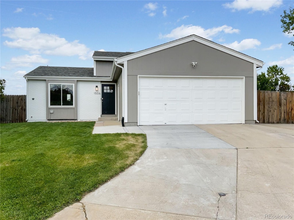 single story home featuring a garage, concrete driveway, a front lawn, and fence