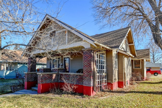 view of home's exterior with a lawn and a porch