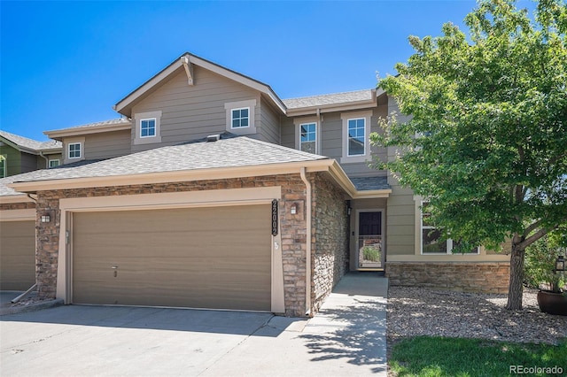 22002 E Irish Dr, Aurora, CO 80016 - view of front of property with stone siding, a shingled roof, concrete driveway, and an attached garage