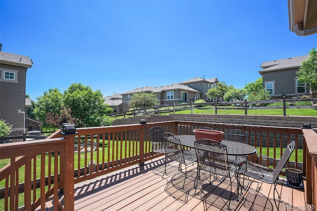 22002 E Irish Dr, Aurora, CO 80016 - wooden terrace featuring outdoor dining area, a residential view, and a fenced backyard