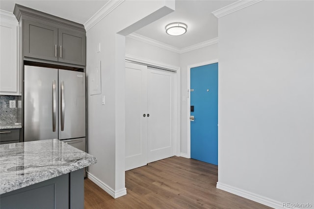 320 S Ames St Unit 5, Lakewood, CO 80226 - kitchen featuring dark wood-type flooring, light stone countertops, baseboards, crown molding, and freestanding refrigerator