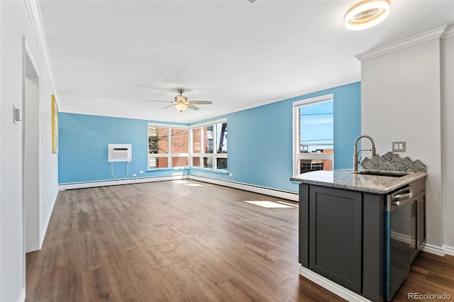320 S Ames St Unit 5, Lakewood, CO 80226 - unfurnished living room featuring a sink, crown molding, ceiling fan, wood finished floors, and baseboards