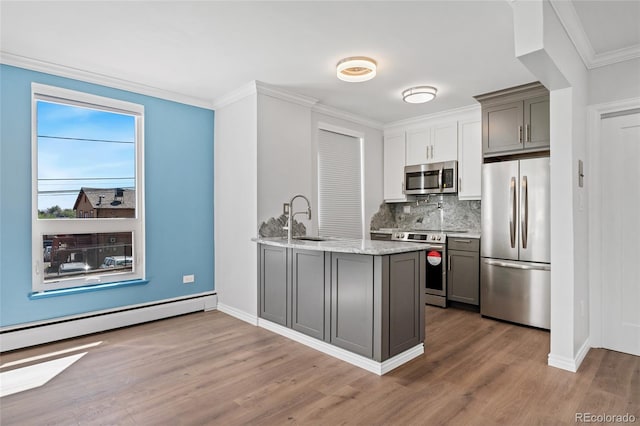 320 S Ames St Unit 5, Lakewood, CO 80226 - kitchen with stainless steel appliances, gray cabinets, wood finished floors, a sink, and ornamental molding