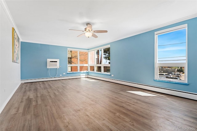 320 S Ames St Unit 5, Lakewood, CO 80226 - empty room with a ceiling fan, wood finished floors, ornamental molding, a wall mounted air conditioner, and baseboards