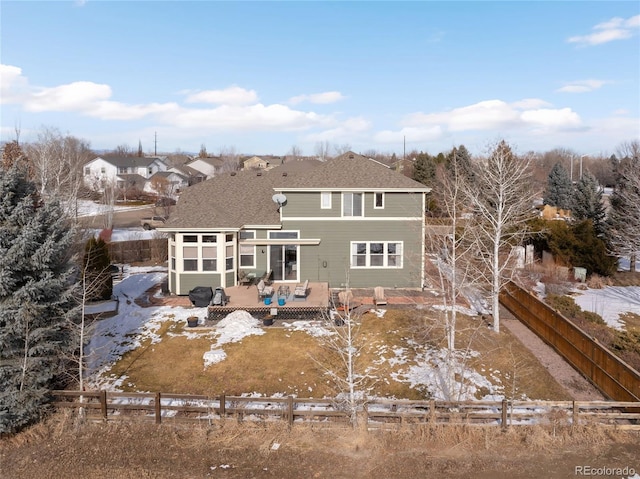 back of house featuring a sunroom and a deck