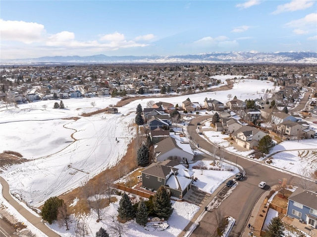 snowy aerial view featuring a mountain view