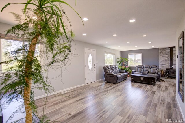 45321 Summit Rd, Parker, CO 80138 - living room featuring recessed lighting, wood finished floors, and a wood stove