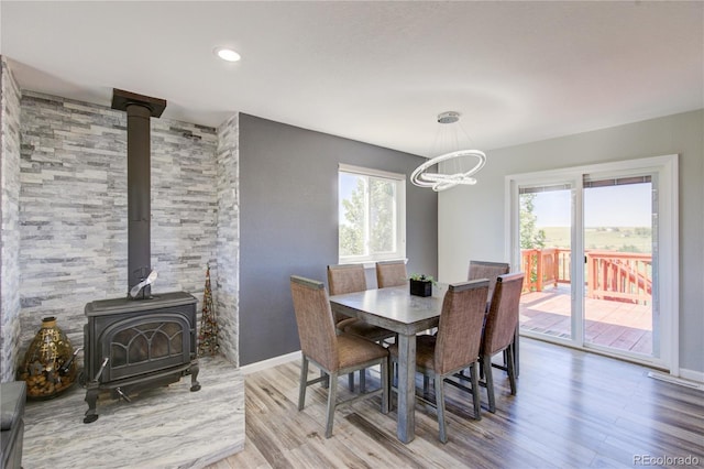 45321 Summit Rd, Parker, CO 80138 - dining room with a wood stove, a chandelier, and wood finished floors