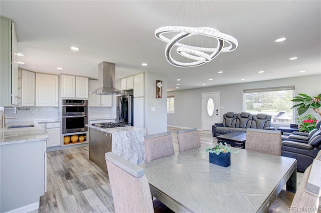 45321 Summit Rd, Parker, CO 80138 - dining area with light wood-style flooring, a chandelier, and recessed lighting