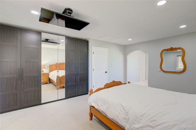 45321 Summit Rd, Parker, CO 80138 - bedroom featuring light carpet, arched walkways, recessed lighting, and a closet