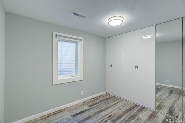 45321 Summit Rd, Parker, CO 80138 - unfurnished bedroom featuring wood finished floors, a closet, and a textured ceiling