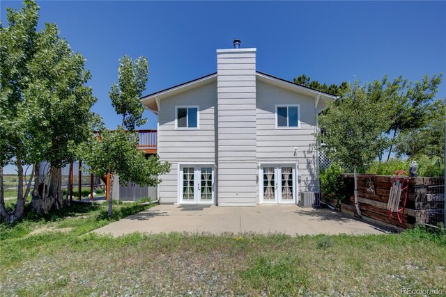 45321 Summit Rd, Parker, CO 80138 - rear view of property with french doors, a patio area, and a chimney