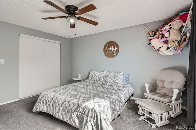 carpeted bedroom with ceiling fan, baseboards, a closet, and a textured ceiling