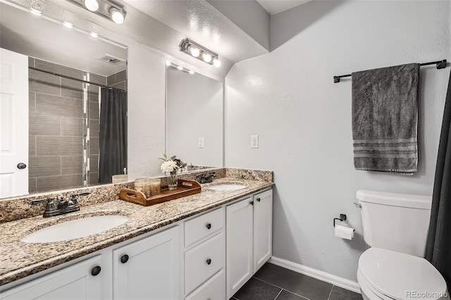 bathroom featuring tile patterned floors, toilet, visible vents, and a sink