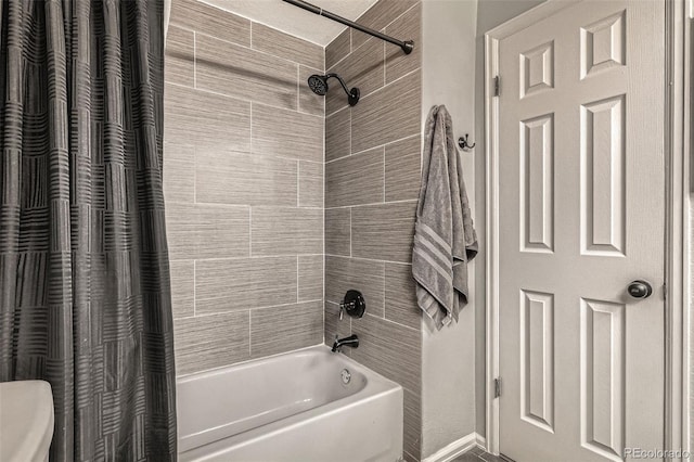 full bath with shower / bath combo with shower curtain and toilet