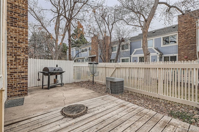 deck with a patio area, grilling area, a residential view, and a fenced backyard